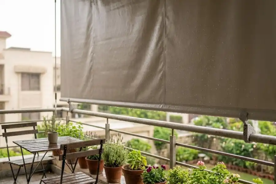 Outdoor Balcony Blinds Waterproof: What Holds Up in Rain and Wind 1 Waterproof PVC roller blind installed on a rainy outdoor balcony, blocking wind and rain